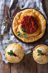 Australian meat pie on a  table. vertical top view closeup