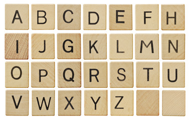 Alphabet letters on wooden scrabble pieces, isolated on white. - Powered by Adobe