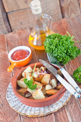 fried potato on plate and on a table
