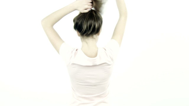 Female teenager undoing bun moving long healthy hair
