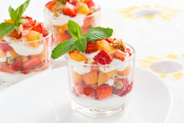 dessert with strawberries, apricots, whipped cream and mint