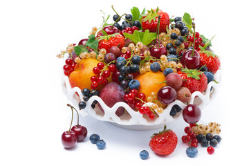 dish with seasonal fruit and berries, close-up, isolated