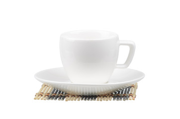 White coffee cup and saucer on a wooden napkin on white