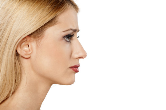 Profile Of Sad Young Blonde On A White Background