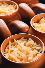 Roast with vegetables, meat and cheese in pottery.