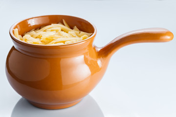 Roast with vegetables, meat and cheese in pottery.