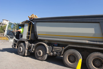 Truck and bulldozer work in the quarry