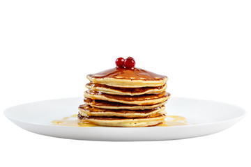 Pancakes with honey and cranberries on a plate. Isolated