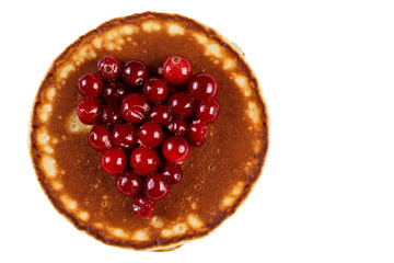 Fried pancakes with cranberries in heart shape isolated on white