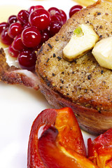 Steak fried in bacon with cranberry, pepper, honey and garlic.