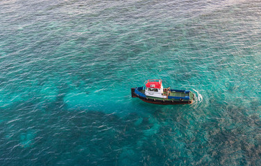 Red White and Blue Pilot Boat in Shallow Aqua Water
