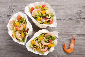 Shrimp salad with grapefruit, orange and roasted peanuts. - Serv