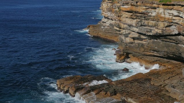 Ocean waves crashing against cliff, South Head, Sydney