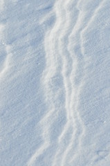 Streaks of snow. Snowflakes on the ice. Winter and frost.