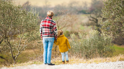 Family walk on the background of the marvelous Tuscan countrysid