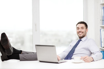 smiling businessman or student with laptop