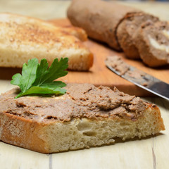 Roll pate, slices of toasted bread. Shallow depth of field.