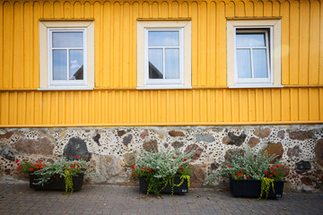 Yellow wooden wall with some windows