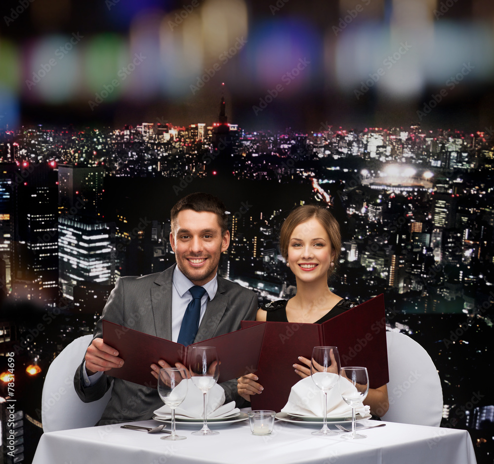 Sticker smiling couple with menus at restaurant