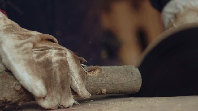 Man chopping firewood with circular saw. Slow motion