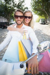 Attractive couple riding a scooter