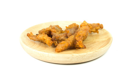 Pork fried on wooden dish, isolated on a white background