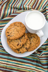 oatmeal raisin cookies and cup of milk