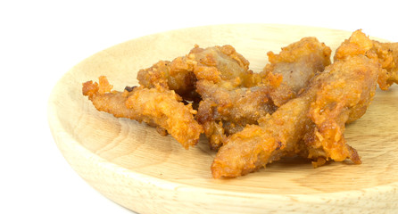 Pork fried on wooden dish, isolated on a white background