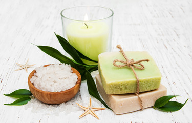 spa setting with candle, handmade soap and salt