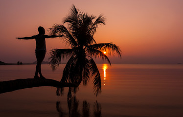 Girl standing on the  palm over water