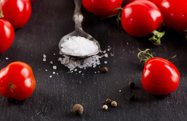 Tomatoes on a  black background.
