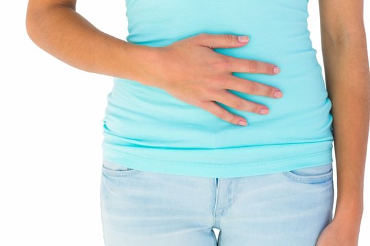 Slim woman with hand on stomach