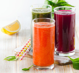 fresh vegetable juices on a wooden background