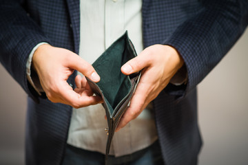 Bankruptcy - Business Person holding an empty wallet - 78319080