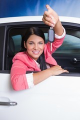 Smiling woman holding car key