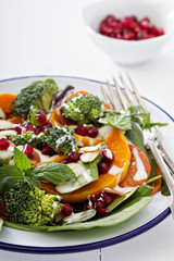 Salad with vegetables, pepperoni and pomergranate