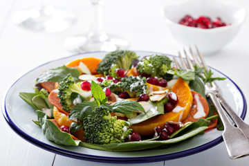 Salad with vegetables, pepperoni and pomergranate