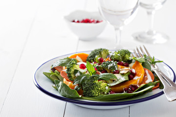 Salad with vegetables, pepperoni and pomergranate