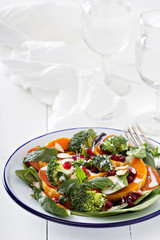 Salad with vegetables, pepperoni and pomergranate