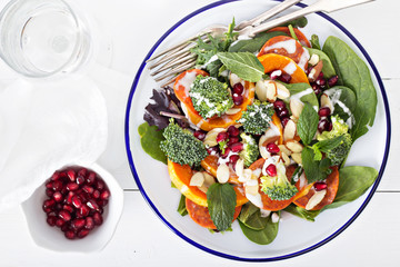 Salad with vegetables, pepperoni and pomergranate