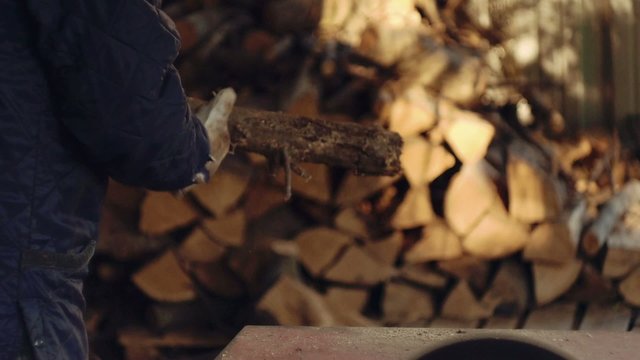 Man chopping firewood with circular saw. Slow motion