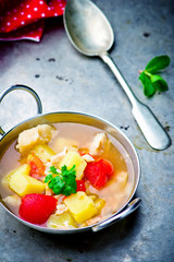 fish vegetables soup in an iron bowl.