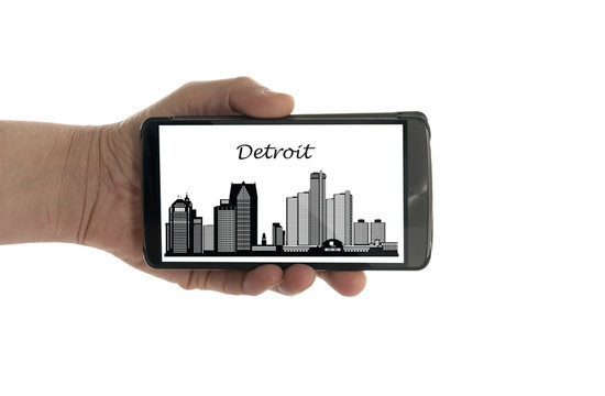 female hand with mobile phone Detroit skyline