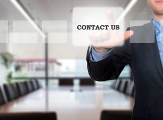 Businessman hand pushing contact us button on a touch screen