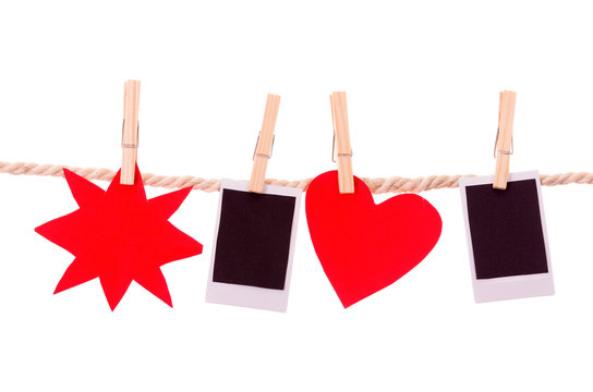 instant photographs and red shapes hanging on a rope clothesline