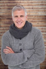 Composite image of casual man in warm clothing