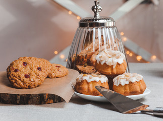 table with cup of coffee and three cupcake  light background