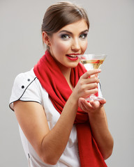 Young girl drink alcohol with glass. Smiling model.