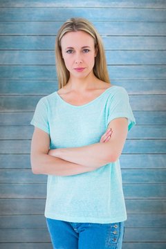 Composite image of serious blond posing with arms crossed