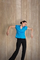 Composite image of young businesswoman hanging like a puppet